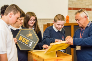 Mark Douglas, co-founder of BEE1, introduces pupils from Ysgol Hendrefelin to their new beehive.