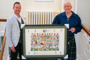 John Savage (left) presents the autographed Celtic print to Danny Byrne.