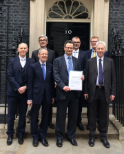 The delegation of industry leaders present the petition on fair payments to Number 10 Downing Street. Left to right: David Frise (back), Brian Berry, Stephen Martin, Steve Bratt (front), Mike Cherry, Peter Aldous MP, and Lord Aberdare.