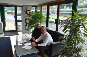 Colt managing director Nick Buckingham (right) signing the new distribution deal with Paul Dunne of ALPS at Colt’s Petersfield HQ