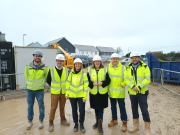 Cherilyn Mackrory, (3rd from R) was shown around the new development by Kensa CEO, Tamsin Lishman (3rd from L)